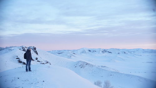 Man snow covered mountain against sky