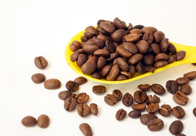 Close-up of roasted coffee beans and white background