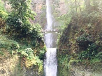 Scenic view of benson bridge against multnomah falls