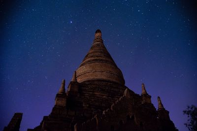 Low angle view of pagoda against sky at night