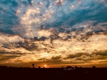 Scenic view of silhouette landscape against dramatic sky