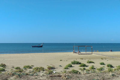 Scenic view of beach against clear sky