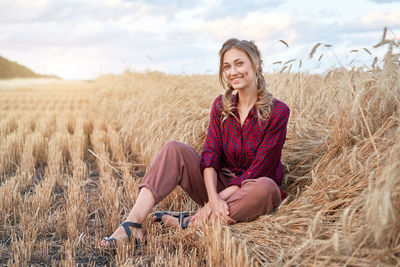 Young woman sitting in the field
