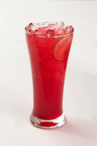 Close-up of red glass against white background