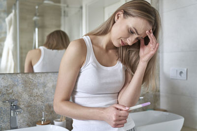 Side view of young woman using mobile phone