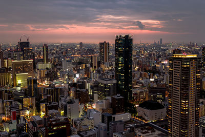 Aerial view of city lit up at night