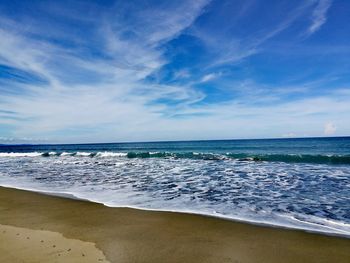Scenic view of sea against blue sky