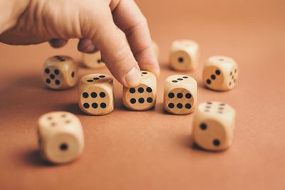 Cropped hand with dices on table