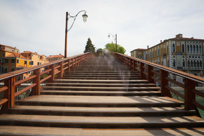 Surface level of empty bridge against sky