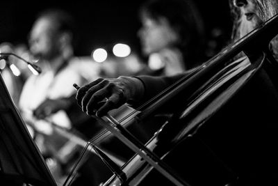 Midsection of woman playing cello