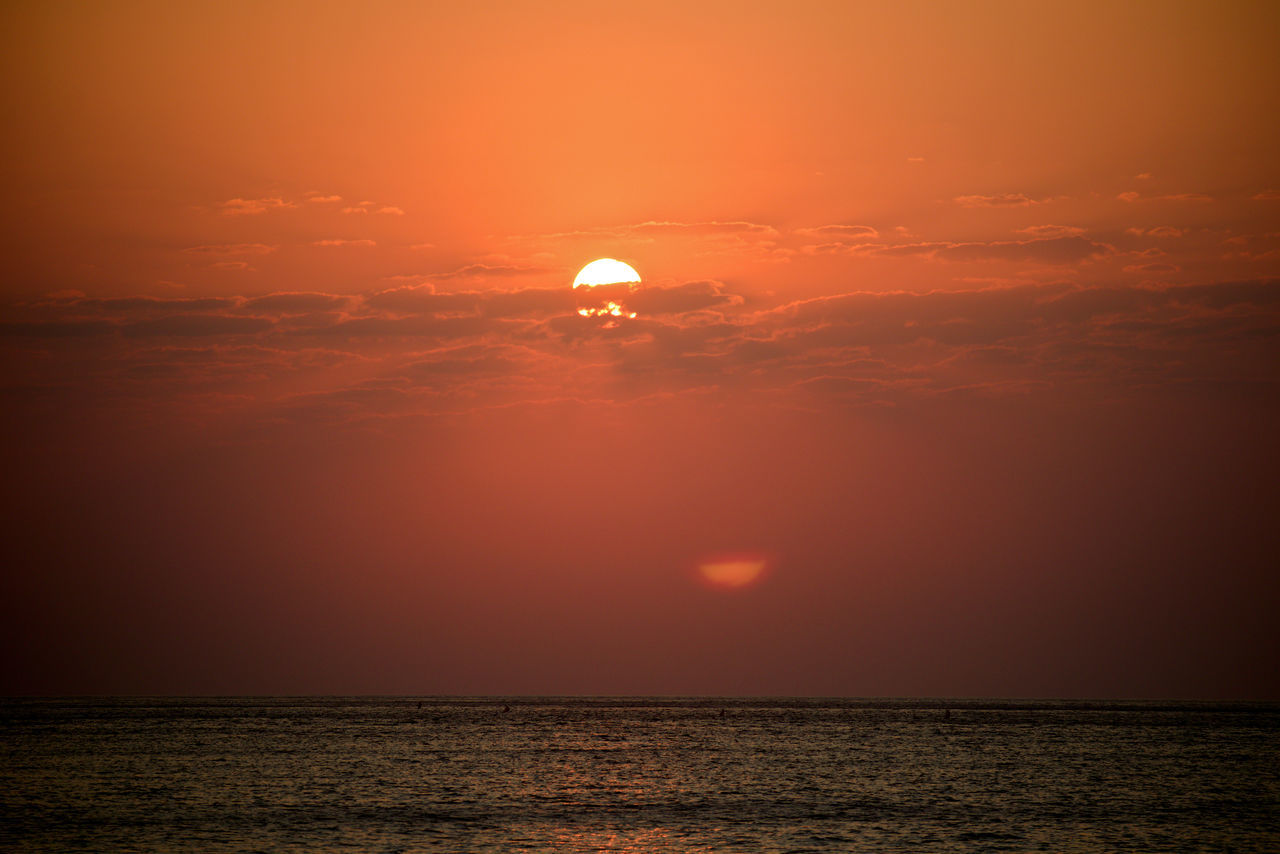 SCENIC VIEW OF SEA AGAINST ORANGE SKY DURING SUNSET