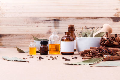 Various cooking oils in bottles by spices on table