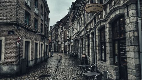 Narrow street amidst buildings in city