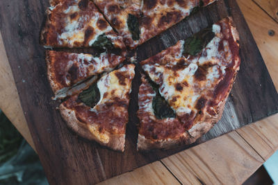 High angle view of pizza on cutting board