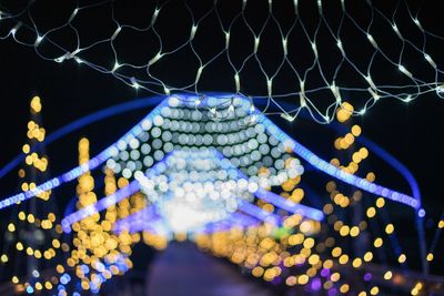 Low angle view of illuminated lights at night