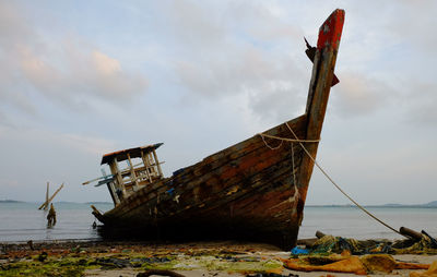 Abandoned boat at coastline