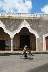 Man riding bicycle on building