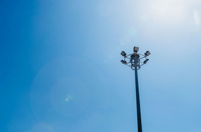 Low angle view of floodlight against clear blue sky