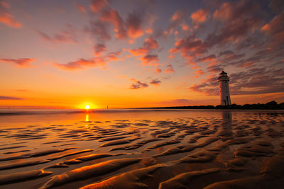 Scenic view of beach against sky during sunset