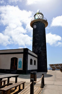 Low angle view of lighthouse against its own building