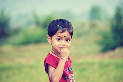 Portrait of cute smiling girl on field