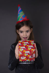 Portrait of a smiling girl holding camera