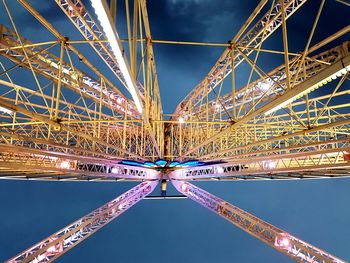 Low angle view of illuminated bridge against sky