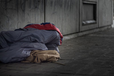 Person sleeping on footpath