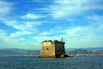 Castle by sea against sky