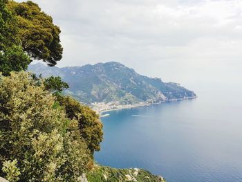 High angle view of sea and mountains against sky