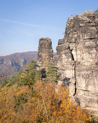 Rock formations on mountain against sky in autumn