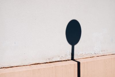 Shadow of sign board on wall