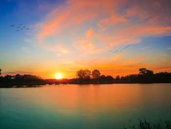 Scenic view of lake against sky during sunset