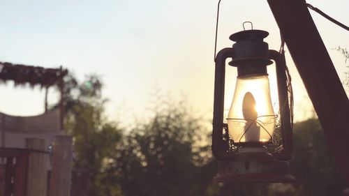Close-up of lantern hanging against sky