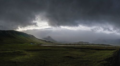 Scenic view of landscape against cloudy sky