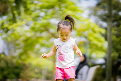 Full length of cute baby girl against trees