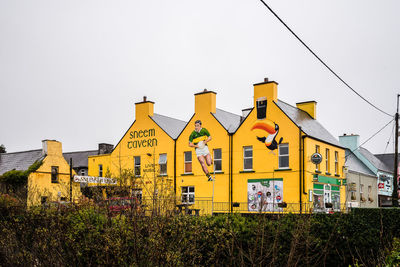 Low angle view of yellow buildings against clear sky