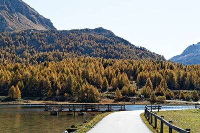 Scenic view of lake and mountains against clear sky