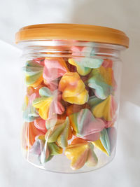High angle view of candies in glass jar on table