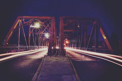 Illuminated bridge at night