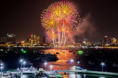 Fantastic and colorful fireworks display over the night sky of the city during a festival