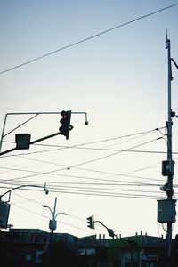 Low angle view of traffic signal against clear sky