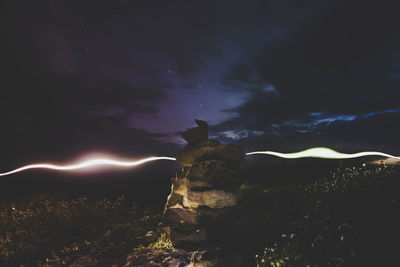Illuminated water against sky at night