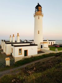Lighthouse against sky during sunset
