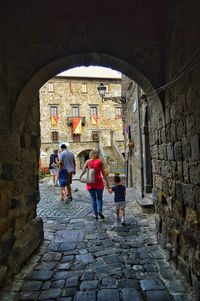 Rear view of people walking in historic building