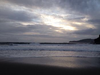 Scenic view of sea against cloudy sky