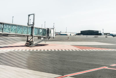 Airplane on airport runway against clear sky