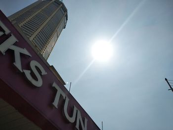 Low angle view of text on building against sky