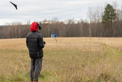 Young man launches rc plane into sky. teenager with glasses playing with toy radio-controlled air