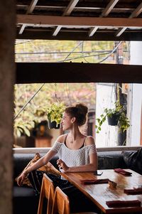 Woman sitting on table in restaurant